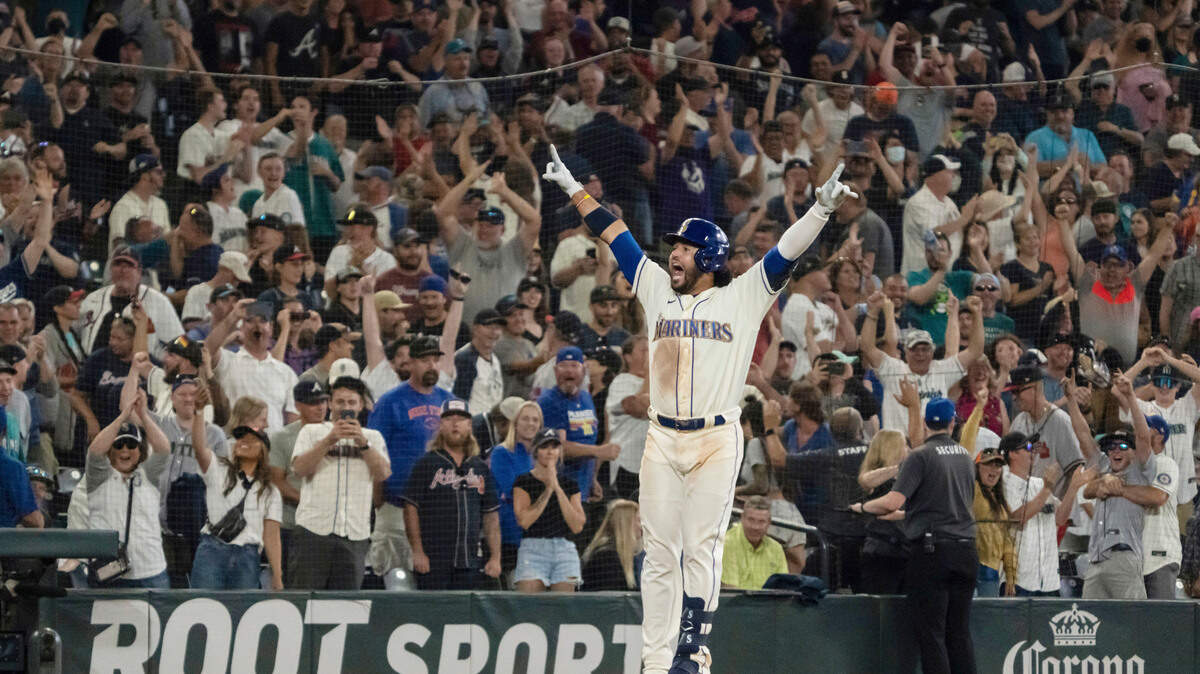 Seattle Mariners’ Eugenio Suarez celebrates hitting a walk-off solo home run off Atlanta Braves relief pitcher Kenley Jansen during the ninth inning of a baseball game, Sunday, Sept. 11, 2022, in Seattle. The Mariners won 8-7. (AP Photo/Stephen Brashear)