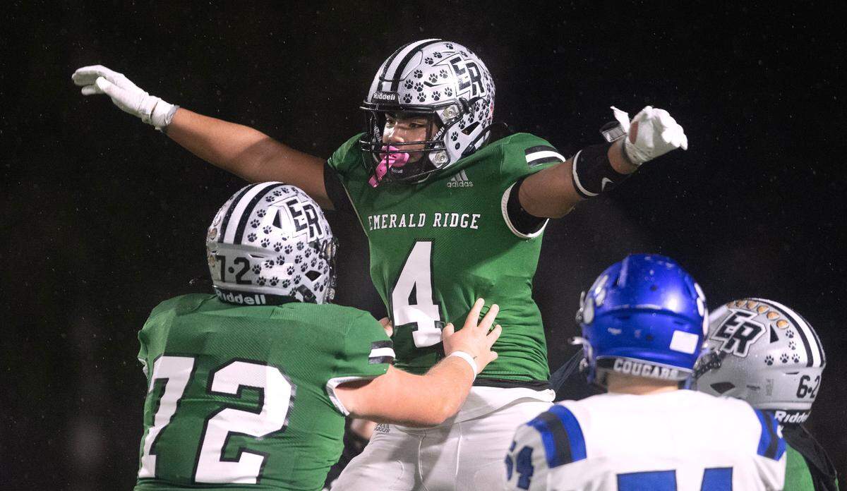 Emerald Ridge running back Navarre Dixon celebrates his touchdown run with lineman Ryan Murphy during Friday night’s 4A district football game against the Bothell Cougars at Sparks Stadium in Puyallup, Washington, on Nov. 3, 2023. Emerald Ridge won the game, 50-36.