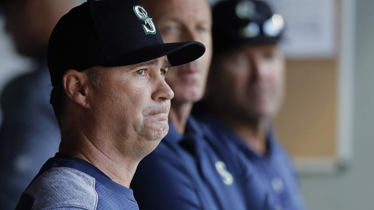 Seattle Mariners manager Scott Servais, left, looks out from the dugout during the fourth inning of a baseball game against the San Diego Padres, Wednesday, Sept. 12, 2018, in Seattle. (AP Photo/Ted S. Warren)