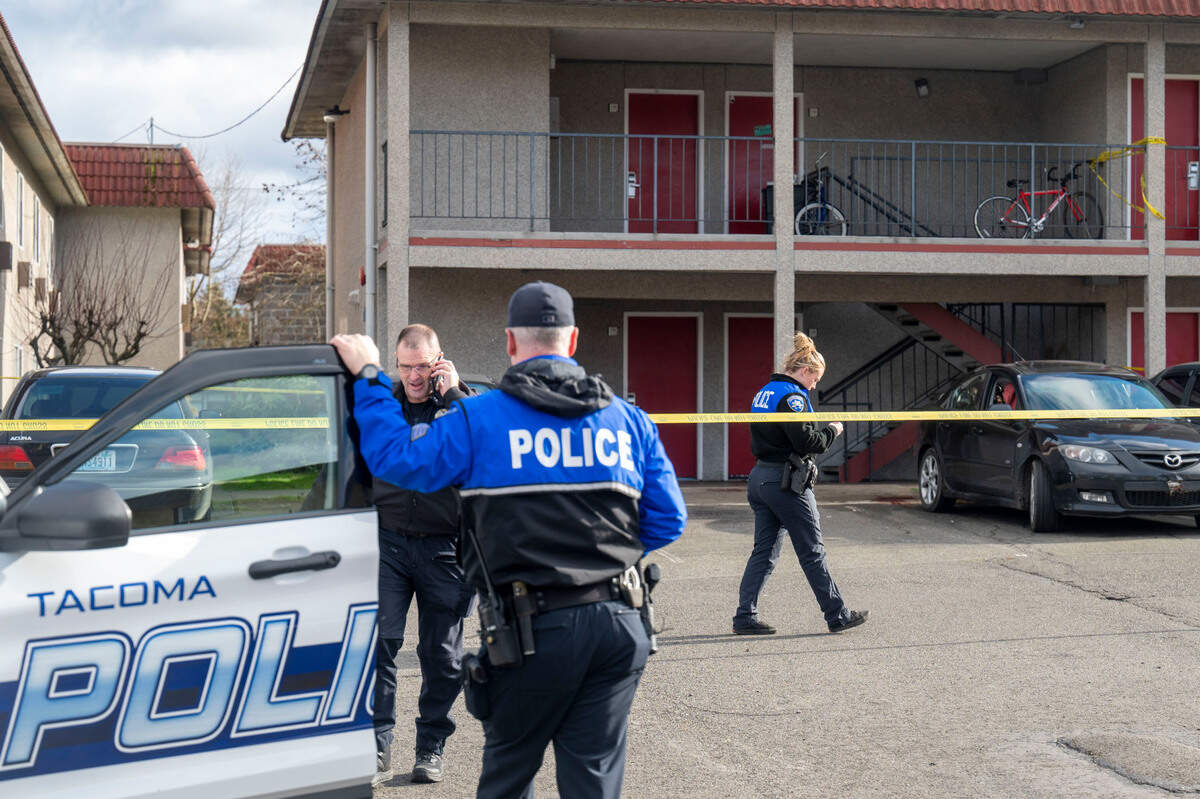 Detectives and crime scene technicians investigate the scene of a suspected fatal shooting on the 8800 block of South Hosmer Street in Tacoma, Wash., on Monday, Feb. 7, 2022.