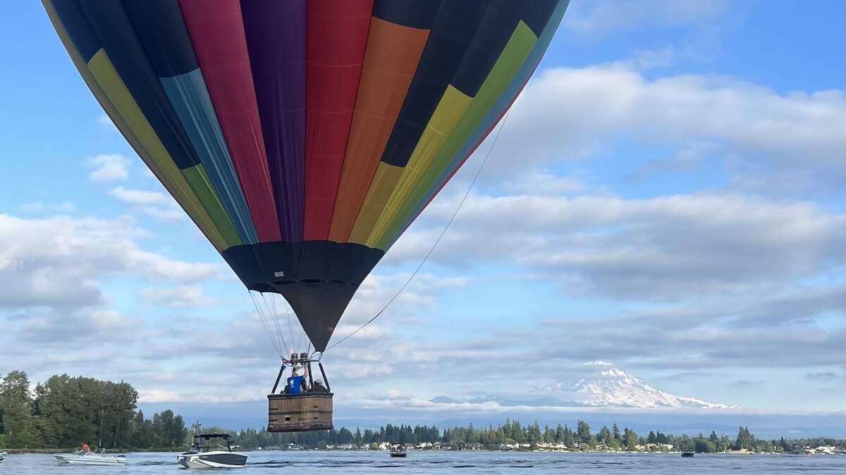 Eliav Cohen, chief pilot and owner of Seattle Ballooning, flying a hot air balloon over Lake Tapps on Sunday, June 11.