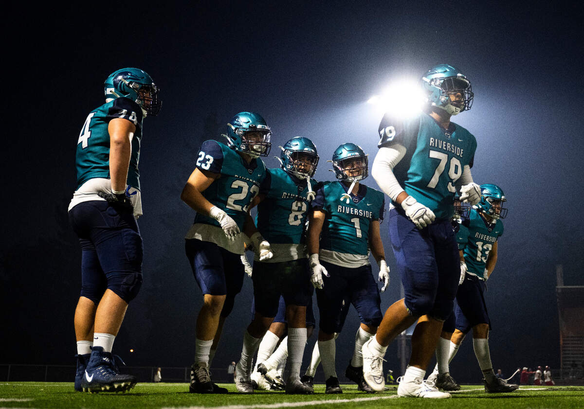 Auburn Riverside defensive players walk off the field during a timeout in the second quarter of a game against Kennedy Catholic at Auburn Memorial Stadium in Auburn, Wash. on Oct. 6, 2022. Kennedy Catholic defeated Auburn Riverside 47-17.