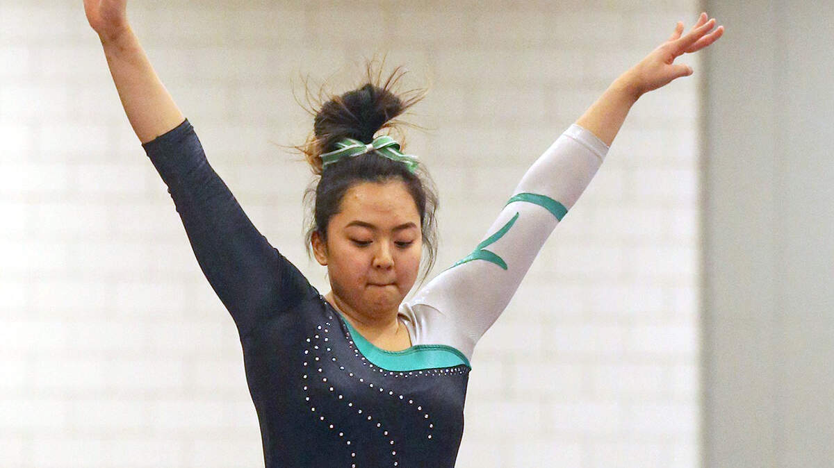 Kentwood’s Ashley Yang, competes on the balance beam at the state gymnastics tournament at Sammamish High School, Friday February 22, 2019.