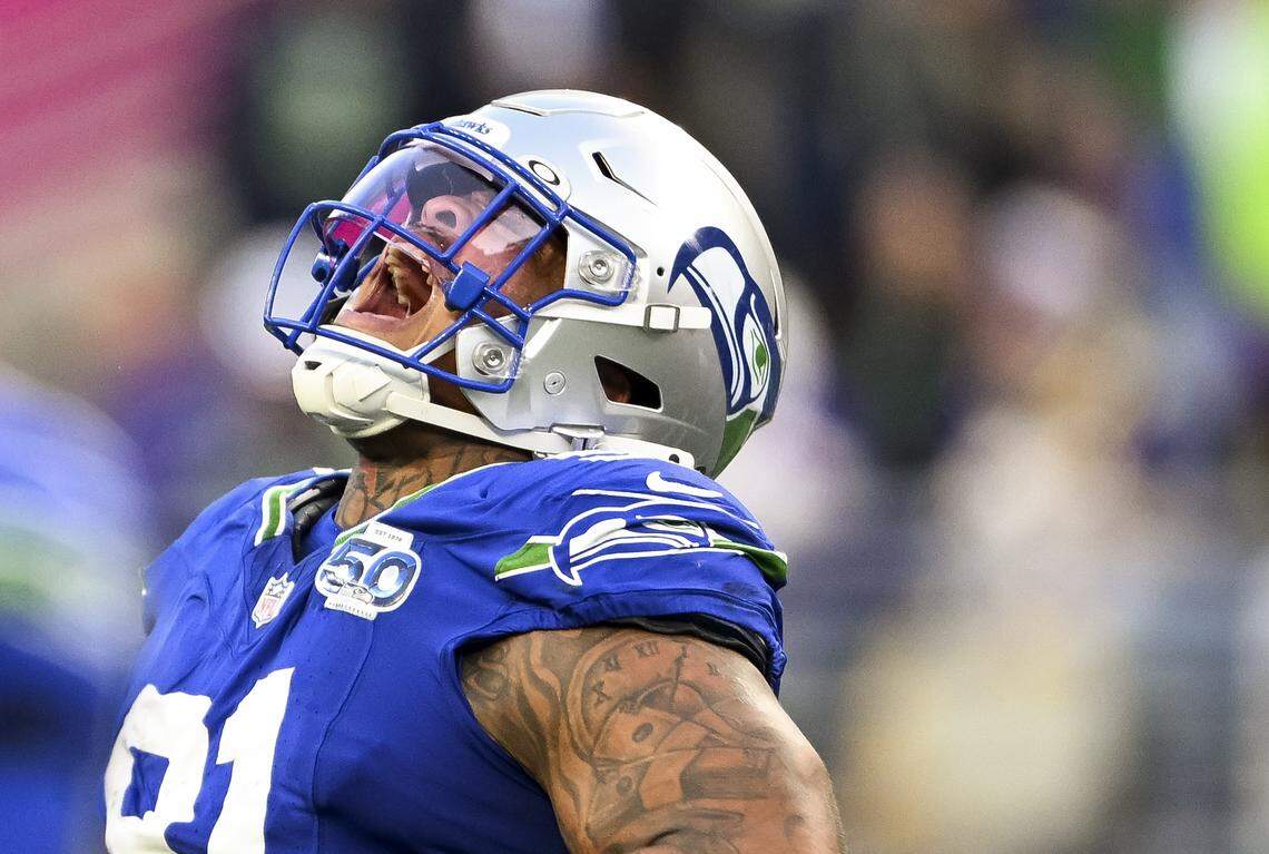 Seattle Seahawks defensive tackle Byron Murphy II (91) reacts to a sack on Minnesota Vikings quarterback Max Brosmer (12) during the fourth quarter of the game at Lumen Field, on Sunday, Nov. 30, 2025, in Seattle.