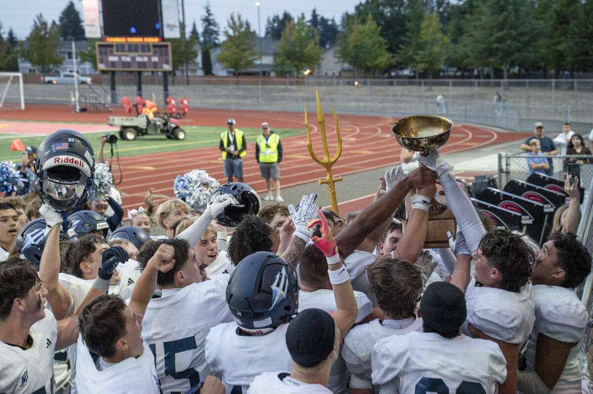 Gig Harbor receives the Fish Bowl trophy after their 35-21 win over Peninsula on Saturday, Sept. 6, 2025, at Mount Tahoma Stadium in Tacoma, Wash.