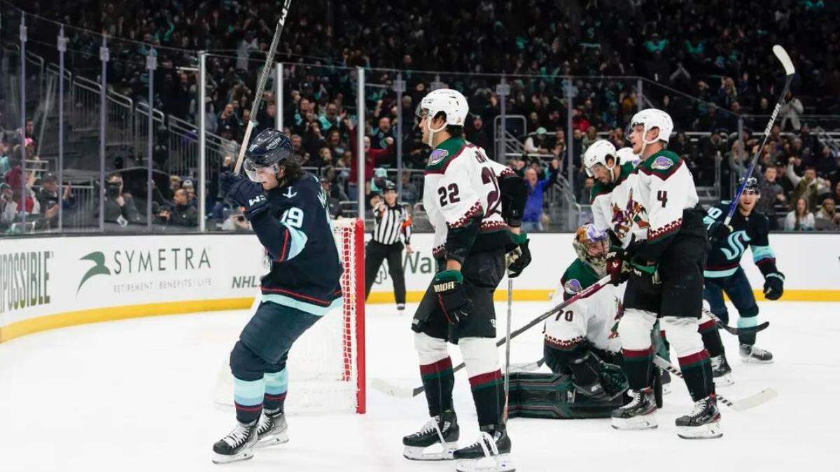 Seattle Kraken left wing Jared McCann, left, celebrates his goal against Arizona Coyotes goaltender Karel Vejmelka (70) during the first period of an NHL game Thursday, April 6, 2023, at Climate Pledge Arena. The Kraken won 4-2 to clinch their first Stanley Cup Playoffs appearance.