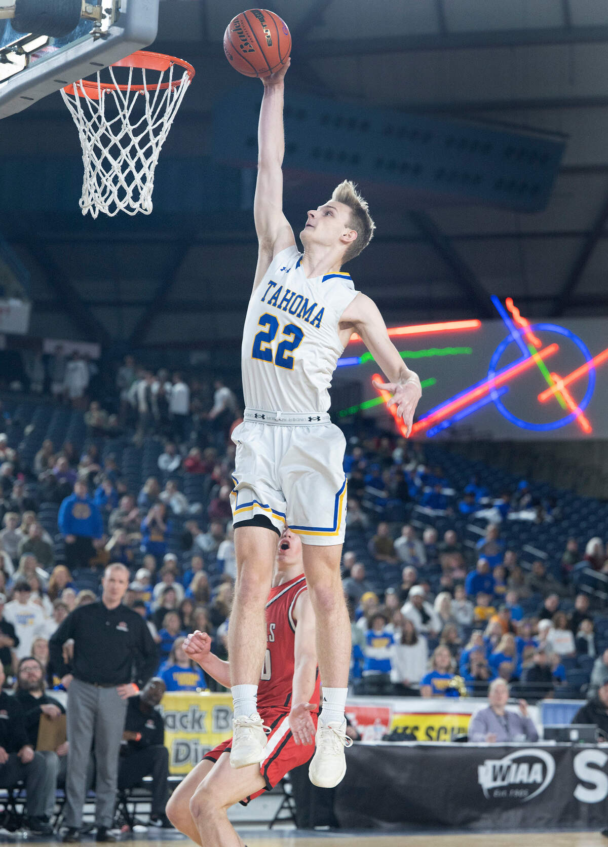 Tahoma’s Adam Davis throws down a dunk in front of Camas defender Theo McMillan during the opening day of the WIAA State Basketball tournament in the Tacoma Dome in Tacoma, Washington, on Wednesday, March 1, 2023. Camas won the game, 62-57.
