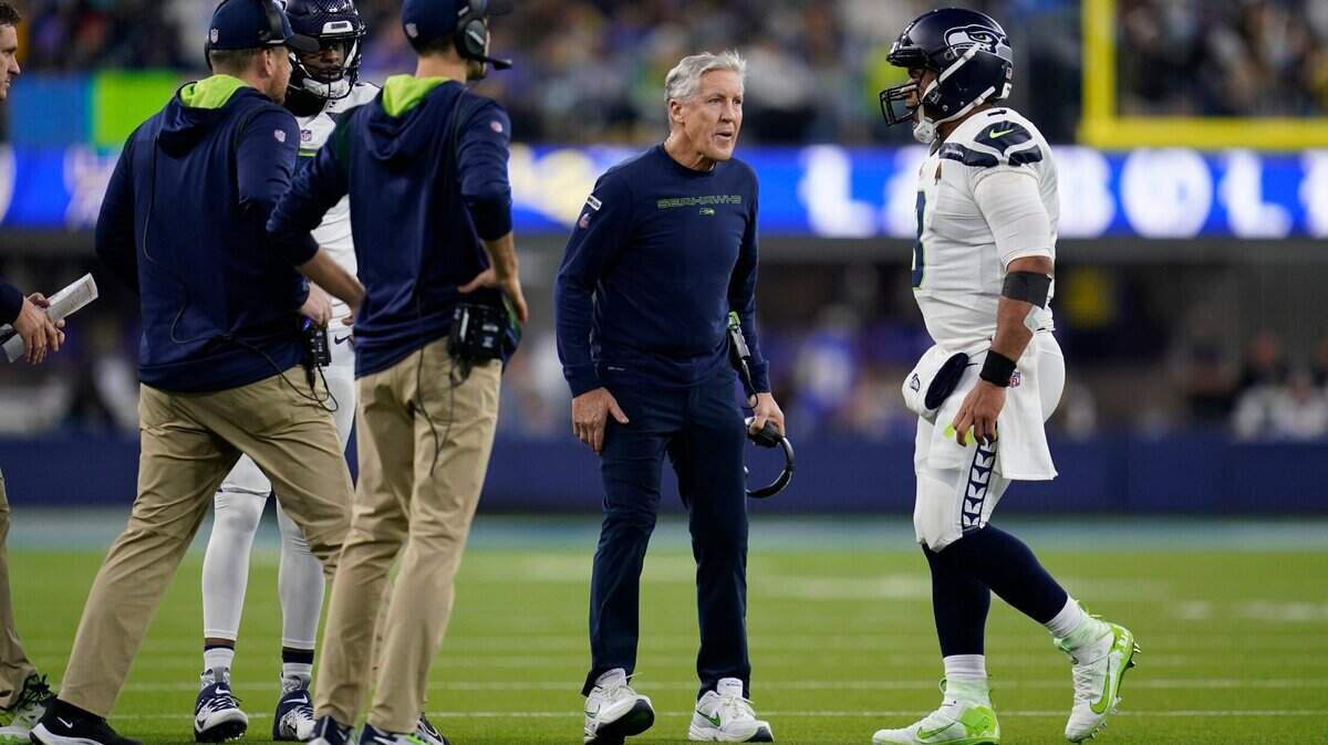 Seattle Seahawks quarterback Russell Wilson, right, walks back to the sideline past head coach Pete Carroll during the first half of an NFL football game against the Los Angeles Rams Tuesday, Dec. 21, 2021, in Inglewood, Calif. (AP Photo/Ashley Landis)