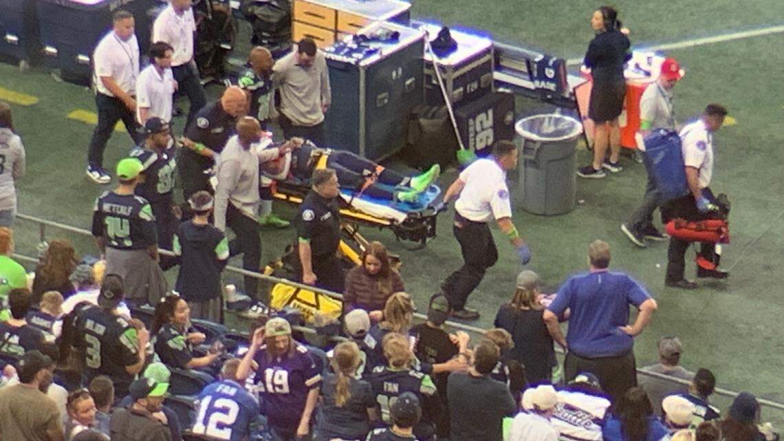 Seahawks wide receiver Cade Johnson leaves Lumen Field’s playing area with his head and neck immobilized to a stretcher during the second quarter of an NFL preseason game against the Minnesota Vikings in Seattle Aug. 10, 2023.