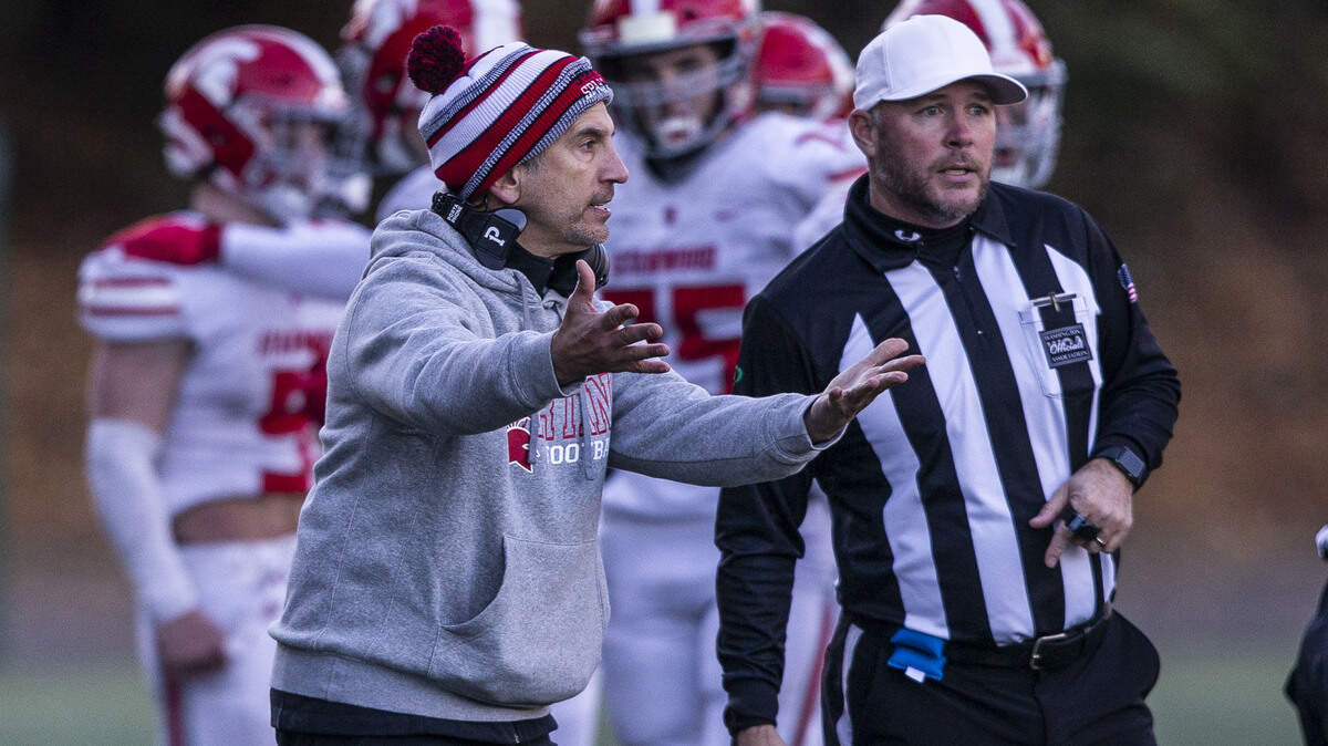 Stanwood head coach Jeff Scoma talks with the referees during the 3A quarterfinal game against Odea on Saturday, Nov. 19, 2022 in Seattle, Washington. (Olivia Vanni / The Herald)