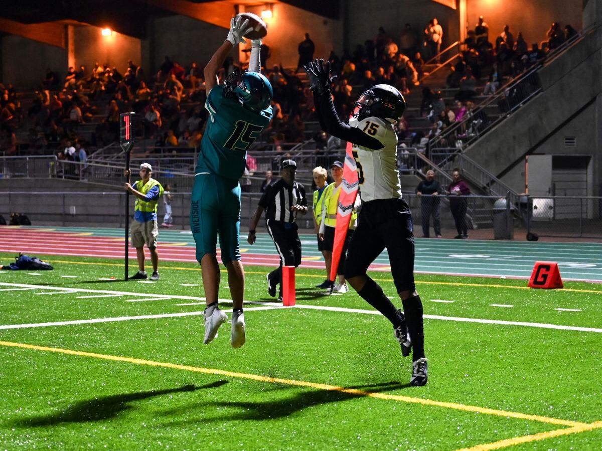 Auburn Riverside’s Isaac Mospanko (15) intercepts the ball in the end zone from Lincoln’s Isaac Mospanko (15) during the second half of the high school football game at Auburn Memorial Stadium, Friday, Sept. 1, 2023, Auburn, Wash.