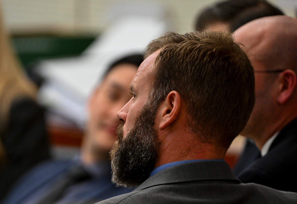 Defendant Matthew Collins looks on as Brian Petersen, a Pierce County Sheriffs Department detective, is questioned under direct examination during the trial of three Tacoma Police officers in the killing of Manny Ellis at Pierce County Superior Court, Tuesday, Oct. 24, 2023, in Tacoma, Wash. Tacoma Police Officers Christopher Burbank, Matthew Collins and Timothy Rankine stand trial for charges related to the March 2020 killing of Manny Ellis. (Brian Hayes / Pool Photo – The News Tribune)