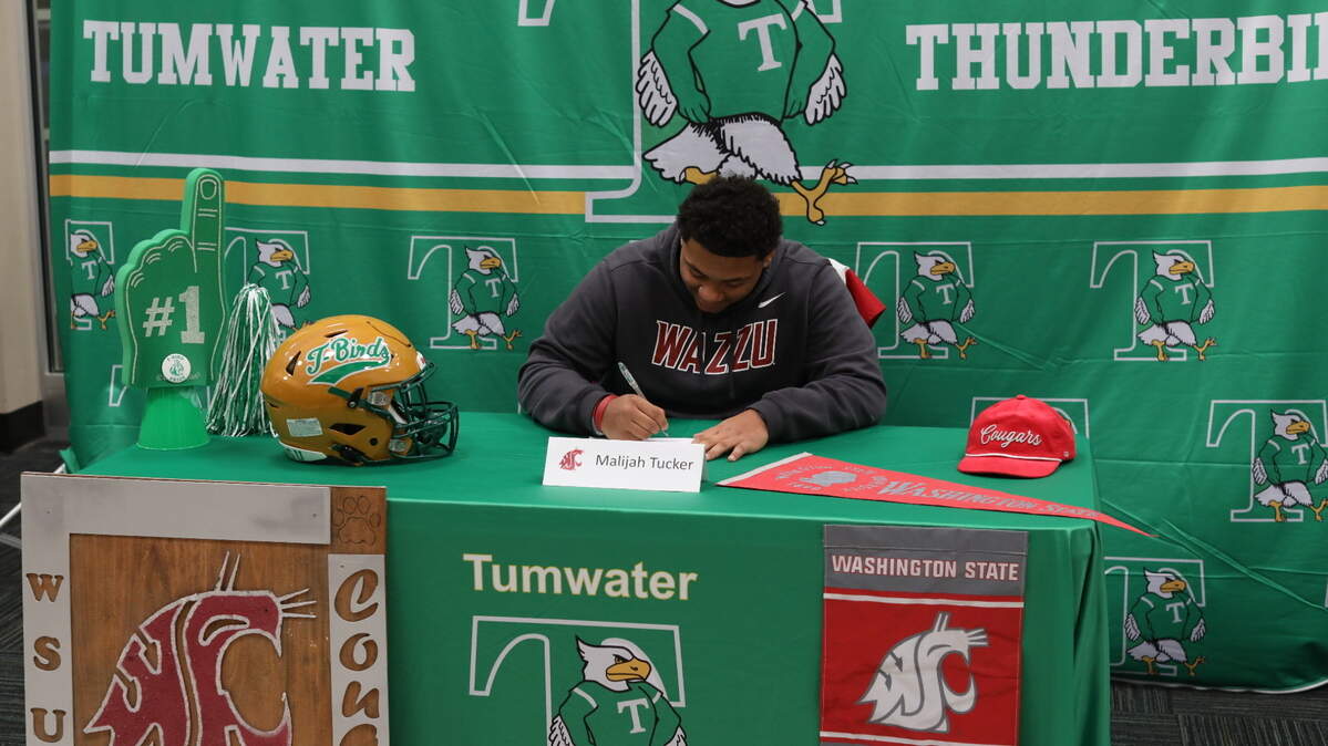 Tumwater’s Malijah Tucker commits to Washington State University on a full football scholarship and signs at Tumwater High School on Dec. 4, 2024.