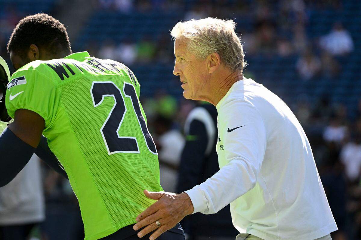 Seahawks head coach Pete Carroll talks with Seattle Seahawks cornerback Devon Witherspoon (21) during warm-ups before the mock game at Lumen Field, Friday, Aug. 4, 2023, in Seattle, Wash.