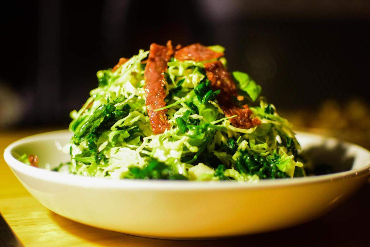 Bar Rosa opened in Tacoma’s Hilltop District in November 2021. With an Italian wood-burning oven as its only cooking surface, the food focuses on Neapolitan pizzas accompanied by amaro-centric cocktails. Pictured here is a shaved Brussels sprouts salad, a recent special.
