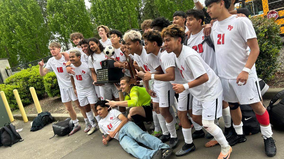 The Franklin Pierce Cardinals soccer team celebrates after winning Saturday’s 2A title.