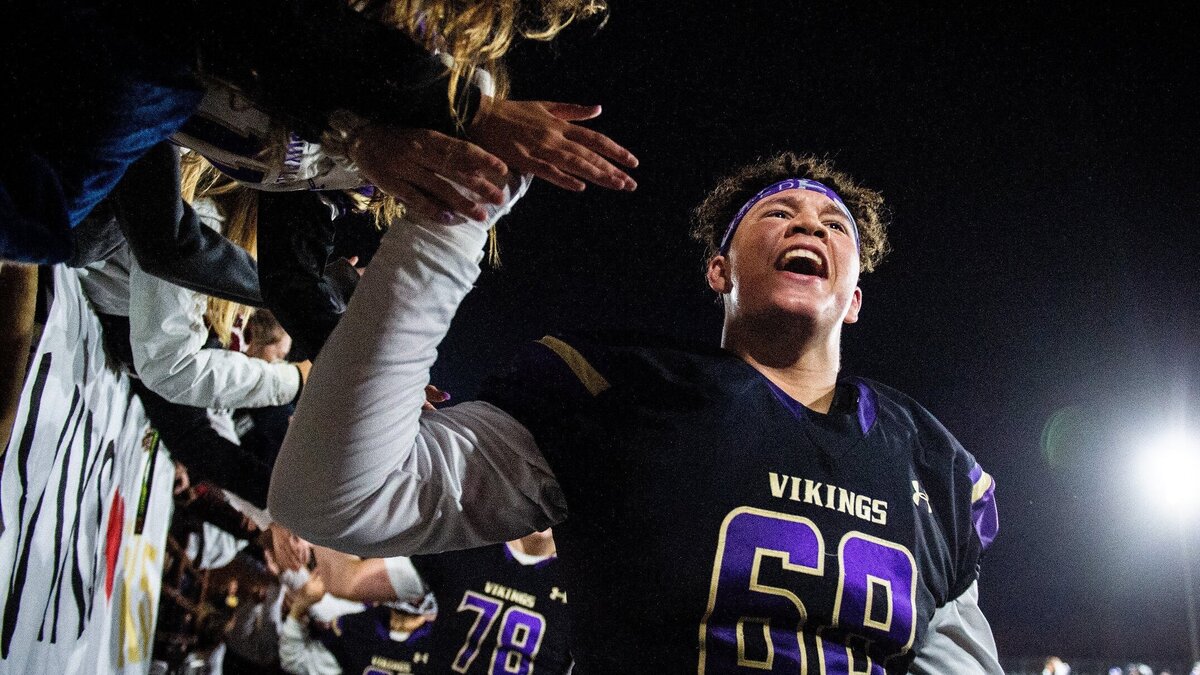 Puyallup’s Braeden Bellmer (68) celebrates with students after the game. Puyallup High School played Kennedy Catholic High School in a football game at Sparks Stadium in Puyallup, Wash., on Friday, Nov. 2, 2018. 

