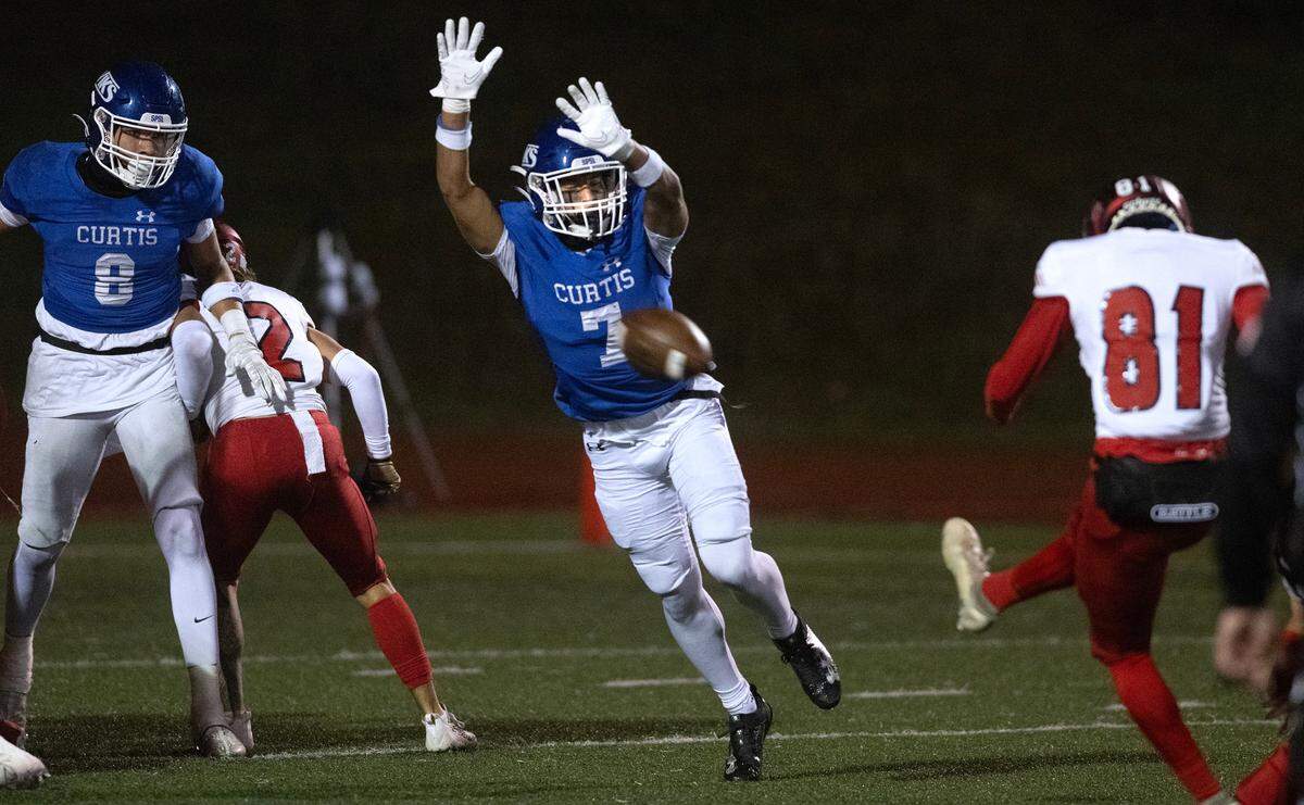 Curtis defender Jayden Rice-Claiborne lays out in pursuit of an extra-point kick by Kennedy Catholic’s Ryan Thomas during Friday night’s 4A state football opening round game at Viking Stadium in University Place, Washington, on Nov. 10, 2023. Kennedy Catholic won the game, 37-34.