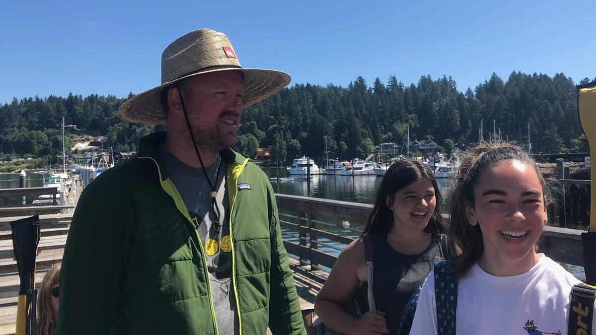 Gig Harbor Canoe and Kayak Race Team coach Aaron Huston, left, at Skansie Park on Tuesday morning with Sadie Hanks, middle, and Zoe Hein, from the San Diego Kayak Team.