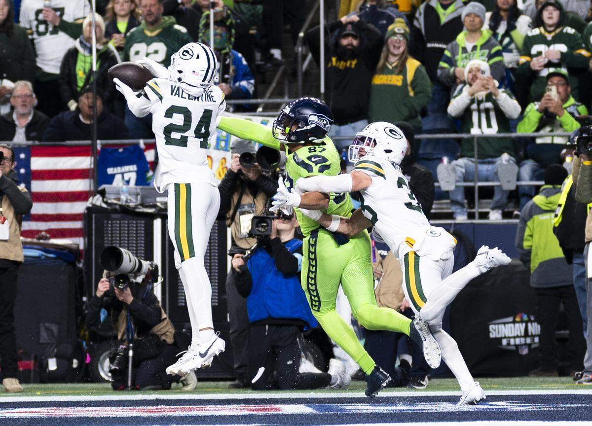 Green Bay Packers cornerback Carrington Valentine (24) intercepts a pass from Seattle Seahawks quarterback Geno Smith (7) intended for Seattle Seahawks tight end Noah Fant (87) during the second quarter of the game at Lumen Field, on Sunday, Dec. 15, 2024, in Seattle, Wash.
