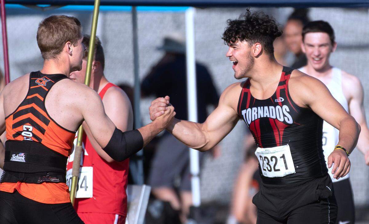 Central Kitsap’s Roderick Schenk (left) is congratulated by Yelm’s Bradyen Platt after throwing a new meet record 219’ 1” in the 3A boys javelin competition during the opening day of the WIAA state track and field championships at Mount Tahoma High School in Tacoma, Washington, on Thursday, May 25, 2023.