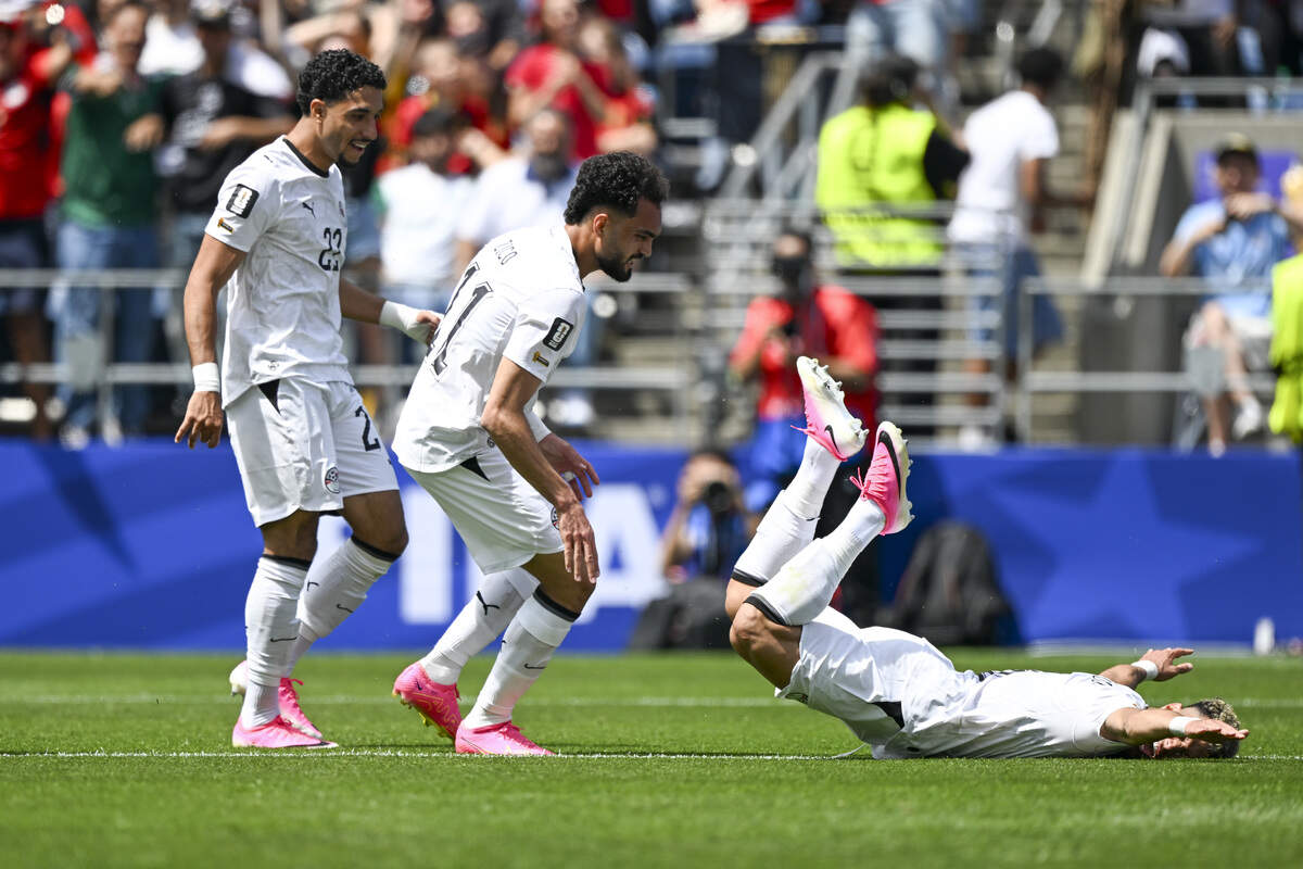 Egypt midfielder Emam Ashour (8), right, is pushed to the ground by Egypt midfielder Mostafa Ziko (11) in celebration of Ashour’s goal against Belgium on Monday, June 15, 2026, during a FIFA World Cup game in Seattle, Wash.