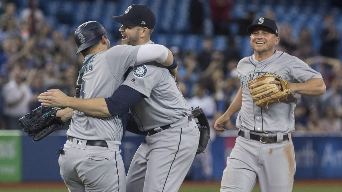 Seattle Mariners starting pitcher James Paxton, center, celebrates with teammates after throwing a no-hitter against the Toronto Blue Jays in a baseball game Tuesday, May 8, 2018, in Toronto. (Fred Thornhill/The Canadian Press via AP)