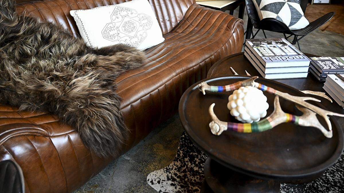 Proprietor Starr Hall curates all the pieces, including this leather couch, at Arch & Starr, shown Wednesday, July 12, 2023, in Gig Harbor, Wash.
