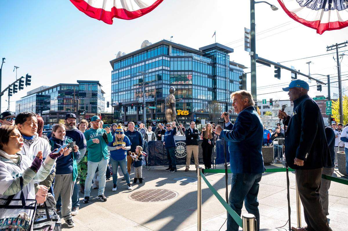 Mariner broadcasters Rick Rizzs (left) and Dave Sims address the crowd waiting to come into T-Mobile Park prior to the gates opening for the Mariners home opener on Friday, April 15, 2022, in Seattle, Wash.
