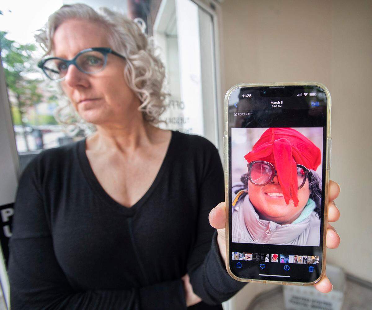 Business owner Jill Fish shows a photo on Thursday, May 5, 2022, of her friend Odessa Easterlin, a homeless woman who had been sleeping on the sidewalk outside Fish’s business on Market Street in downtown Tacoma for the past three years. Easterlin was fatally stabbed April 30. “She was a very very giving generous person even though she didn’t have much. She was not a thief,” Fish said after news reports that Easterlin was killed by a store clerk allegeding she was shoplifting. “I loved her. Everyone is devastated.”