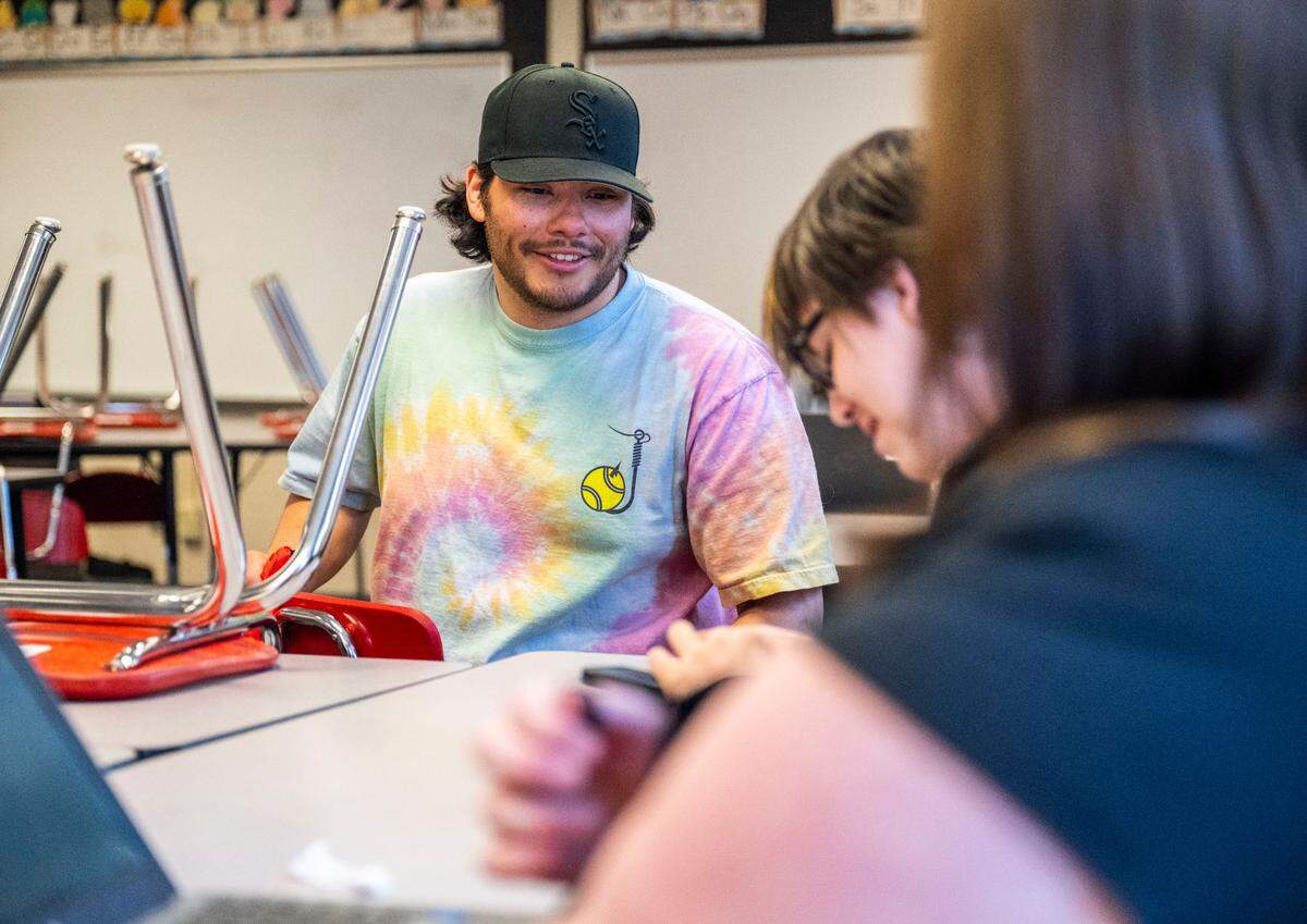 Orting High School Spanish teacher and culture club advisor Mauricio Portillo talks with a student during a culture club meeting in his classroom after school, on May 8, 2023. Portillo’s goal is to create a safe space for underrepresented students.