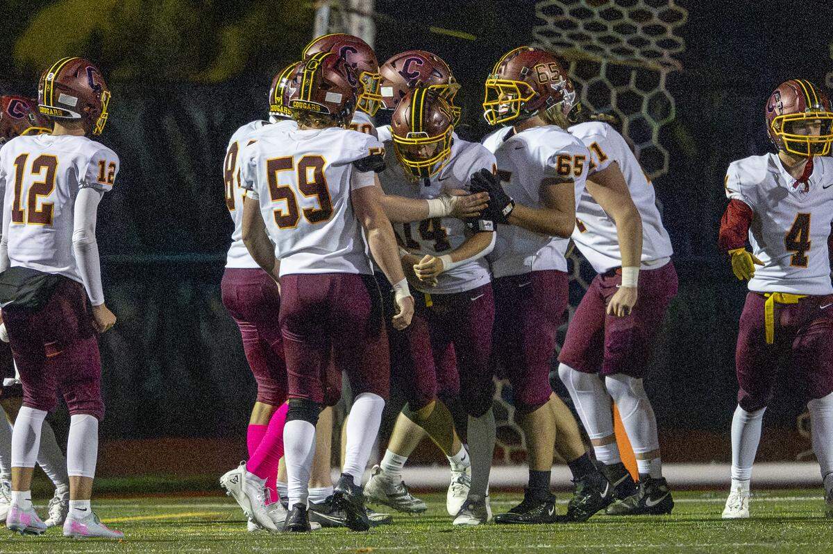 Capital players celebrate Capital running back Garrett Murphy (14) for a touchdown against Lakes on Friday, Oct. 24, 2025, in Lakewood, Wash.