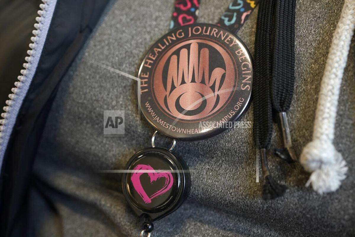 Shawna Priest, a member of the Jamestown S’Klallam Tribe, wears a pin with the logo of the Jamestown Healing Clinic where she works as a medical assistant, Wednesday, Feb. 2, 2022, in Sequim, Wash., as she talks about the battles her son and daughter have had with opioid addiction. The tribe is building a full-service health center to treat both tribal members and other community residents for opioid addictions. Earlier in the week, Native American tribes across the U.S. settled a lawsuit against drug maker Johnson & Johnson and the largest three drug distribution companies in the U.S. for $590 million. The money won’t be distributed quickly, but tribal leaders say it will play a part in healing their communities from an epidemic that has disproportionately killed Native Americans. (AP Photo/Ted S. Warren)