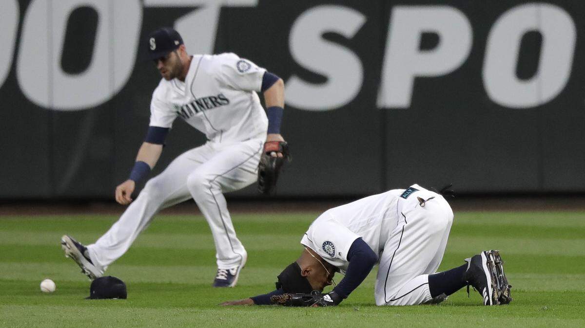 Seattle Mariners center fielder Mallex Smith, right, reacts after he dove for, but couldn’t catch, a single hit by Houston Astros’ Josh Reddick during the sixth inning of a baseball game, Monday, June 3, 2019, in Seattle. At left, right fielder Mitch Haniger reaches for the ball to make the throw.