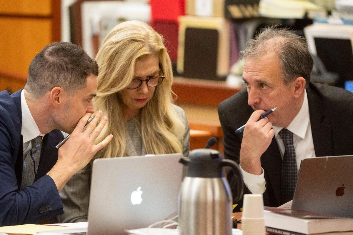 Pierce County Sheriff Ed Troyer (right) talks with his lawyers Anne Bremner (center) and Nick Gross during jury selection in Pierce County District Court on Wednesday, Nov. 30, 2022, in Tacoma, Wash.