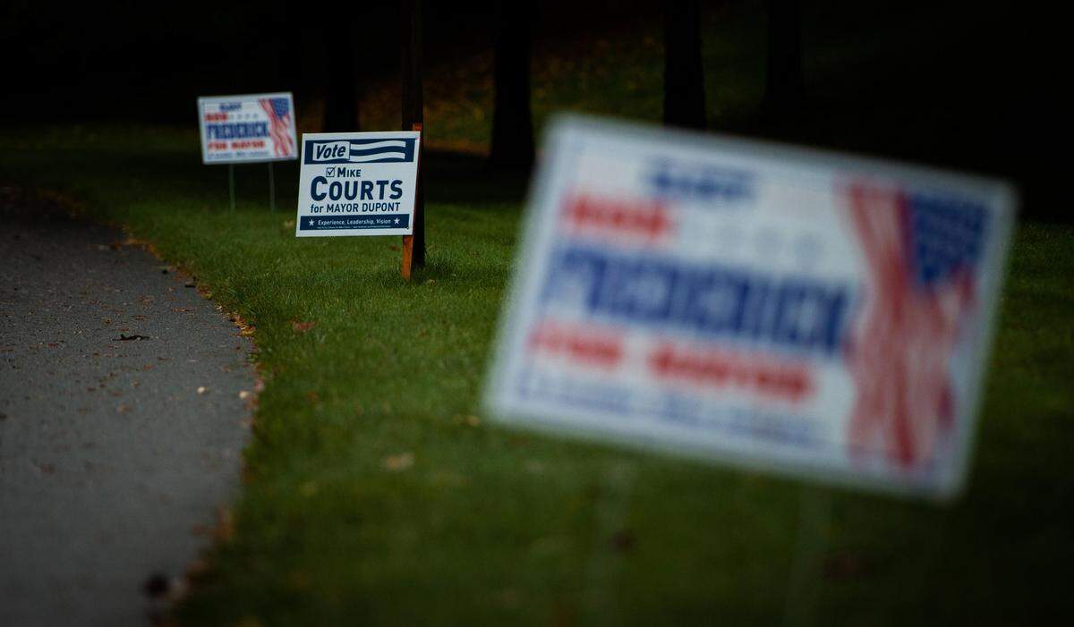 Campaign signs for incumbent Mike Courts and challenger Ron Frederick are seen along a road in DuPont, Oct. 19, 2019.