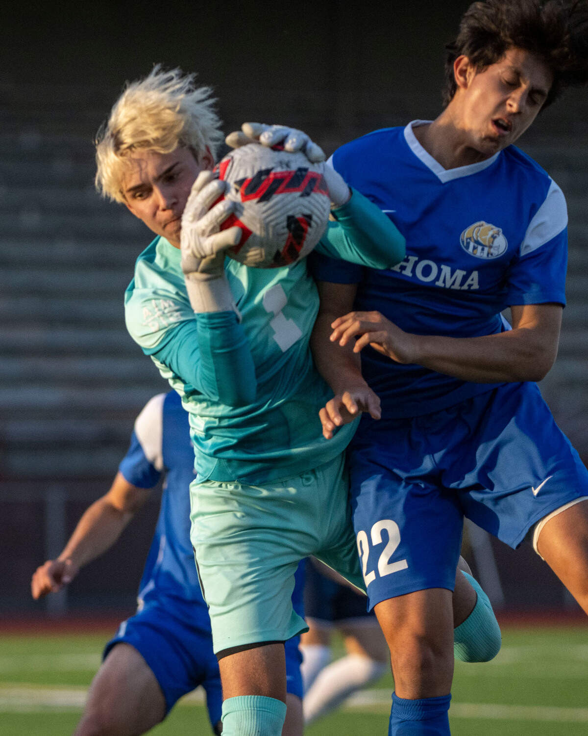 Tahoma’s Pablo Flores collides with Bellarmine Prep goalkeeper Ethan Faini has he grabs a free kick in the penalty area during the first half of the 4A West Central/Southwest district soccer championship game on Thursday, May 11, 2023, at Sparks Stadium in Puyallup, Wash.