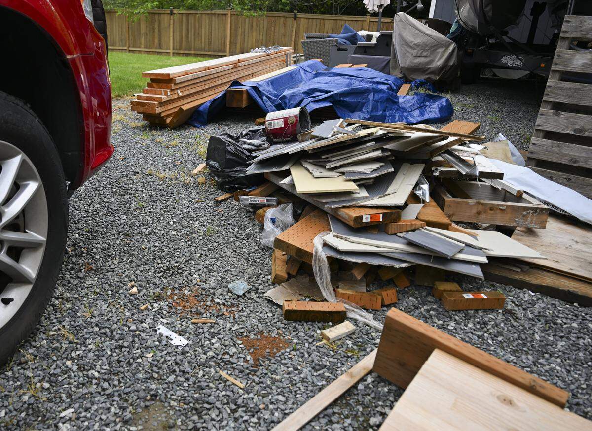Debris and cigarette butts left behind by Construction Kings sit in the backyard near an unfinished deck at the home of Brittany Gunderson on Friday, May 15, 2026, in Bonney Lake, Wash. Gunderson said the deck was being built for her disabled brother-in-law so he could spend time with family at home.