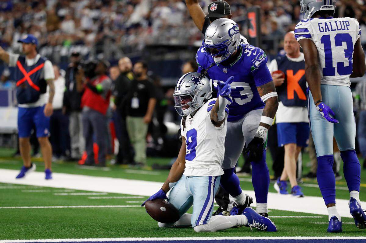 Dallas Cowboys wide receiver KaVontae Turpin (9) celebrates catching a pass for a firs down as Seattle Seahawks safety Jamal Adams (33) looks on in the first half of an NFL football game in Arlington, Texas, Thursday, Nov. 30, 2023. (AP Photo/Roger Steinman)