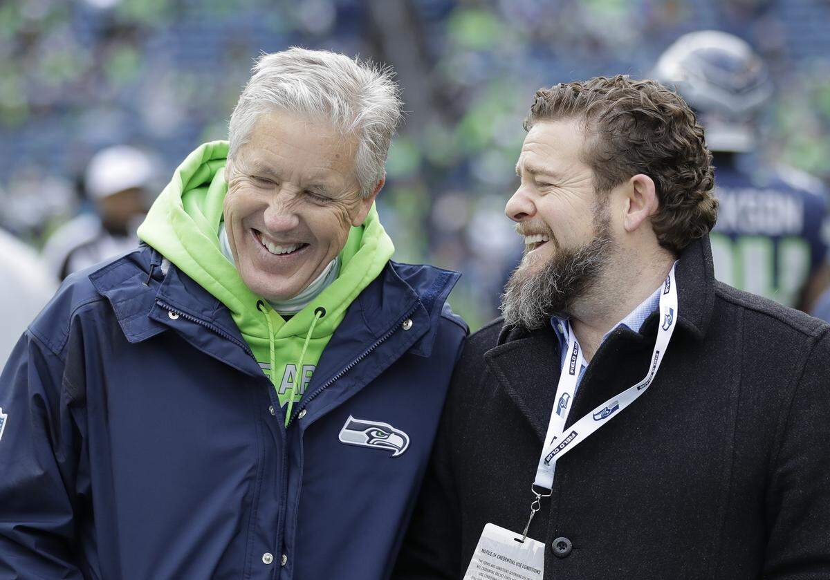 Seattle Seahawks head coach Pete Carroll, left, talks with general manager John Schneider before the first half of an NFL football game against the Arizona Cardinals, Sunday, Dec. 30, 2018, in Seattle. (AP Photo/Ted S. Warren)