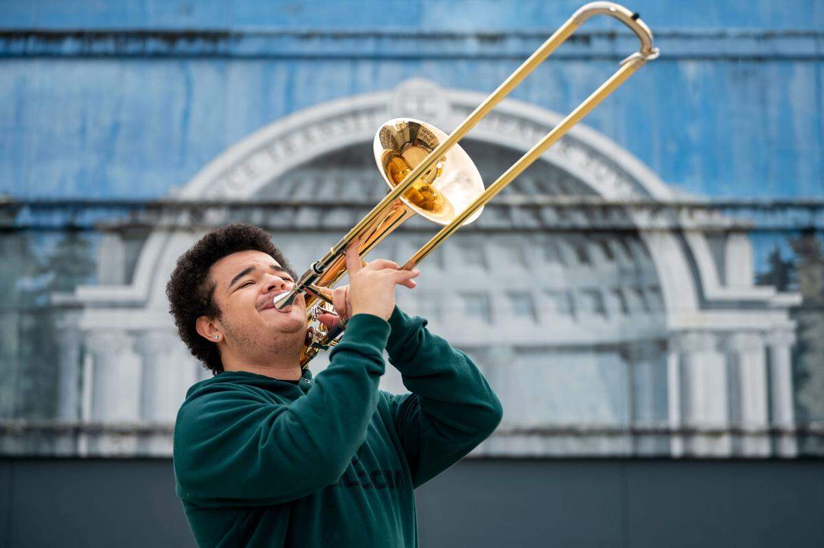 Sabien Kinchlow-McConnaughey, a senior from Bethel High School, plays the trombone in downtown Tacoma, Wash., on Saturday, Jan. 22, 2022. The Honors Performance Series, a performing arts organization, recently offered Sabien Kinchlow-McConnaughey an opportunity to play with other young musicians in early February at Carnegie Hall in New York City.