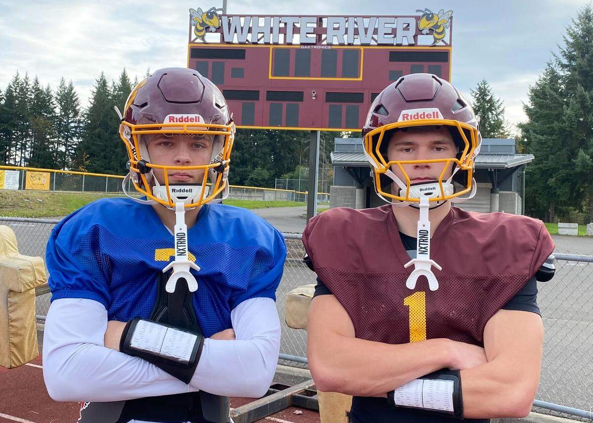 White River QB Chaz Strickland (left) and WR Parker Fry pose for a portrait during practice at White River High School’s Arrow Lumber Stadium on Oct. 16, 2025, in Buckley, Wash.