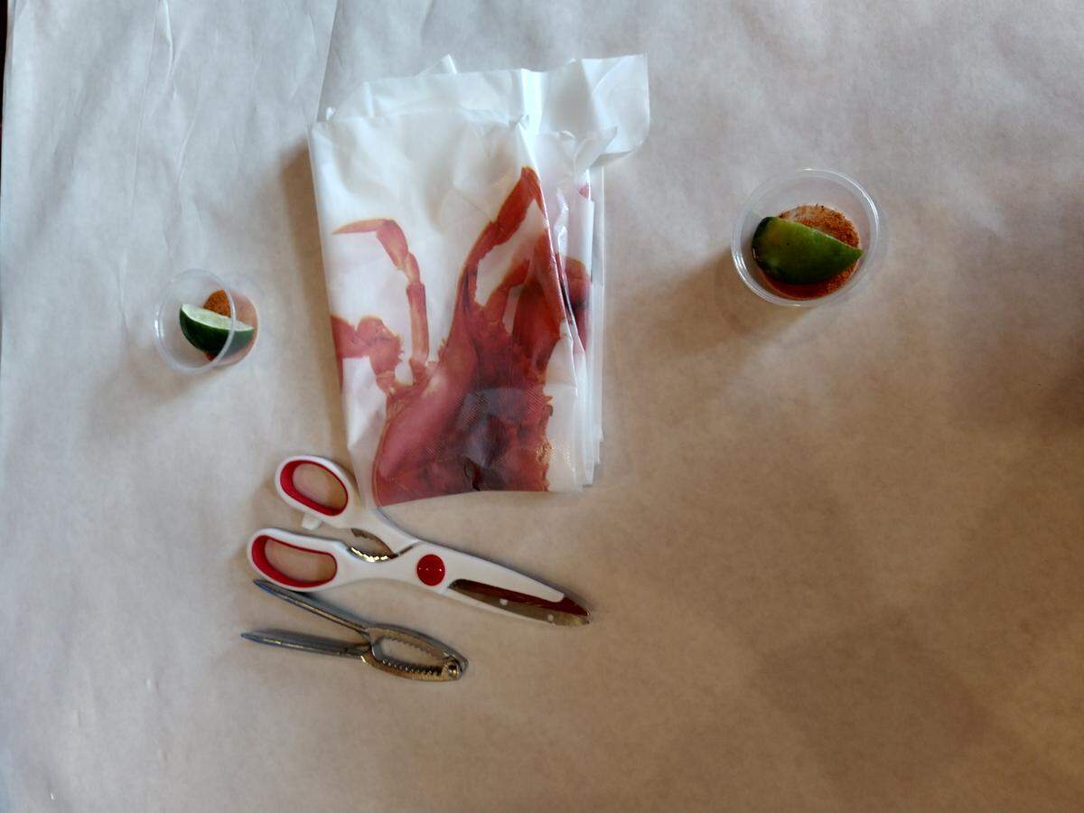 Crab crackers, scissors for cutting shells, bibs and plastic gloves are among the accessories diners are given to make eating seafood boil easier.