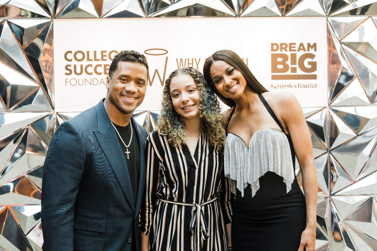 Former Seahawks quarterback Russell Wilson and his wife Ciara returned to Seattle May 21, 2022, on the 10th anniversary of his first visit to Seattle Children’s hospital and to host a dinner event for his Why Not You Academy school in south King County. Here Wilson and his wife are with Trinity, a student at the Why Not You Academy.