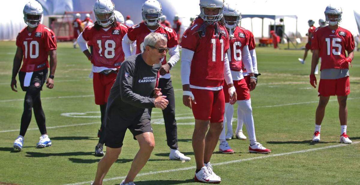 Jerry Sullivan, a 74-year-old veteran coach who many consider a guru and even a “legend” for his work with wide receivers, works with 11-time Pro Bowl veteran Larry Fitzgerald (11) and other Cardinals receivers during a minicamp in Arizona this spring.
