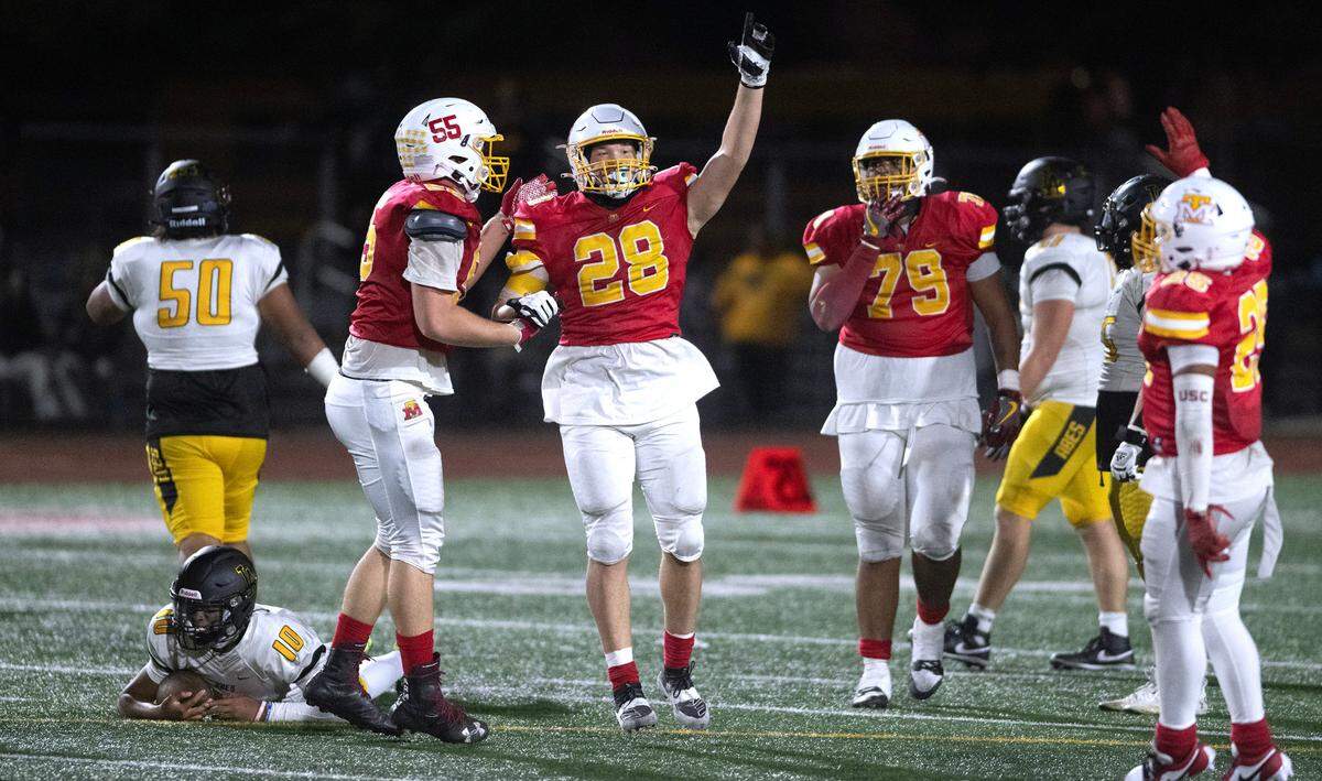 Mount Tahoma defenders Malachi Neilsen (from left), Jeremiah Anderson, Marquise Thorpe-Taylor and Felix Diaz celebrate after sacking Lincoln quarterback Sione Kaho (bottom left) to run out the clock on Friday night’s football game at Mount Tahoma High School in Tacoma, Washington, on Sept. 20, 2023. Mount Tahoma won the game, 24-20.