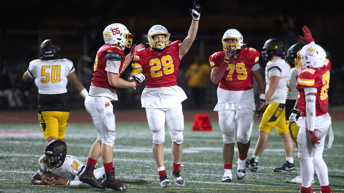 Mount Tahoma defenders Malachi Neilsen (from left), Jeremiah Anderson, Marquise Thorpe-Taylor and Felix Diaz celebrate after sacking Lincoln quarterback Sione Kaho (bottom left) to run out the clock on Friday night’s football game at Mount Tahoma High School in Tacoma, Washington, on Sept. 20, 2023. Mount Tahoma won the game, 24-20.