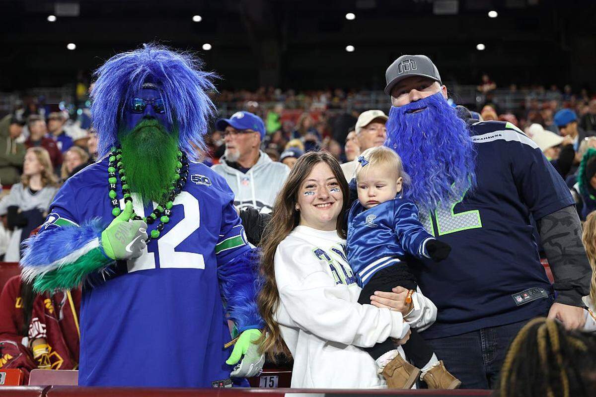 Seattle Seahawks fans pose prior to the game against the Washington Commanders at Northwest Stadium on November 02, 2025 in Landover, Maryland. (Photo by Scott Taetsch/Getty Images)