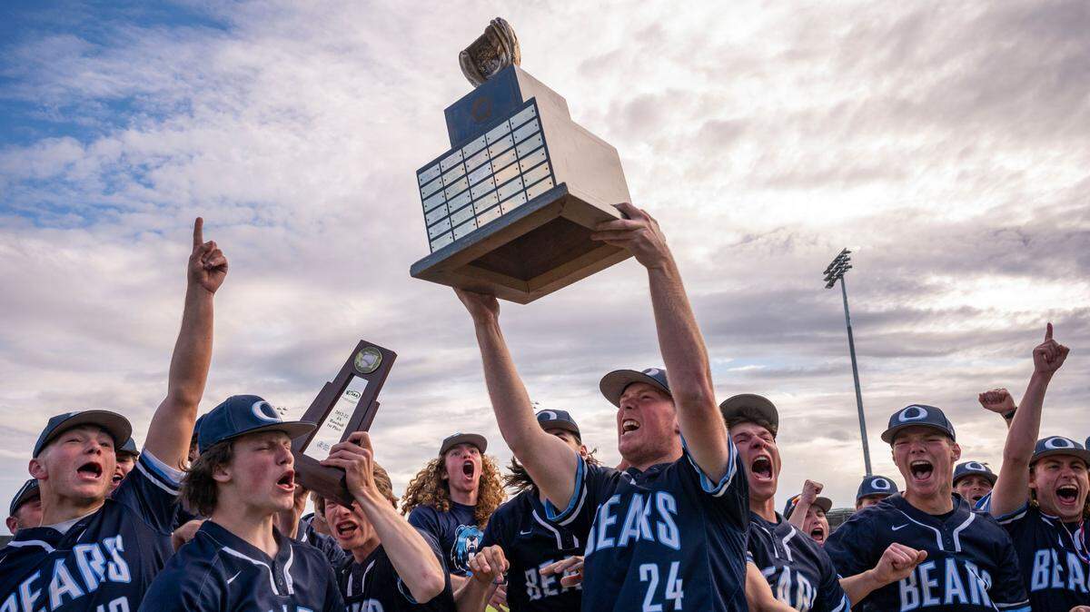 Olympia players hoist the State 4A baseball trophy after beating Puyallup, 7-6, in the championship game at Gesa Stadium on Saturday, May 28, 2022, in Pasco, Wash.