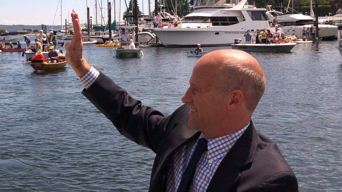 Mayor Kit Kuhn waves during a boat parade in 2019.